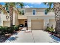 Inviting townhome with a one-car garage, cozy seating, and vibrant landscaping at 9720 Hound Chase Dr, Gibsonton, FL 33534