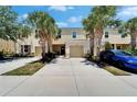 Attractive townhome with an attached garage, a charming entryway and mature landscaping at 9720 Hound Chase Dr, Gibsonton, FL 33534