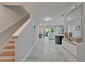 Bright foyer with staircase leading to the open-concept living and dining area at 9720 Hound Chase Dr, Gibsonton, FL 33534