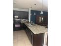 Modern kitchen featuring granite countertops, stainless steel appliances and dark cabinetry at 9833 Hound Chase Dr, Gibsonton, FL 33534