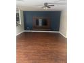 Spacious living room with hardwood floors and media center, perfect for relaxing and entertaining at 9833 Hound Chase Dr, Gibsonton, FL 33534