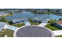 Aerial view of a home located on a waterfront lot in a quiet neighborhood at 1009 Andover Cir, Sun City Center, FL 33573