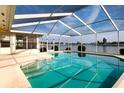 Enclosed pool with clear blue water and a view of the lake beyond at 1009 Andover Cir, Sun City Center, FL 33573
