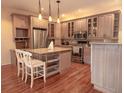 Spacious kitchen featuring granite countertops, stainless steel appliances, and a functional center island for food preparation at 101 8Th St, Belleair Beach, FL 33786