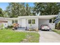 Charming single-story home with a well-manicured lawn, carport and inviting front entrance at 1015 13Th Nw Ave, Largo, FL 33770