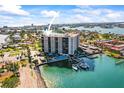 Waterfront condo building with a pool and boat slips offers luxury living with stunning views at 10355 Paradise Blvd # 1003, Treasure Island, FL 33706
