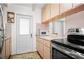 Compact kitchen featuring wood cabinets and stainless steel appliances at 10410 Ventura Ave, Tampa, FL 33619