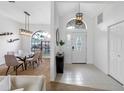 Inviting foyer with modern chandelier, offering a seamless transition to the dining area at 12470 93Rd St, Largo, FL 33773