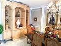 Traditional dining room features a built-in display cabinet, elegant furniture, and artwork adding character to the space at 14711 Potterton Cir, Hudson, FL 34667