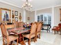 Elegant dining room with chandelier, detailed trim, and space for entertaining at 14711 Potterton Cir, Hudson, FL 34667