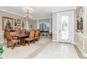 Elegant dining room with chandelier, detailed trim, and space for entertaining at 14711 Potterton Cir, Hudson, FL 34667