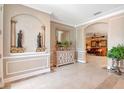 Welcoming foyer with detailed trim work, tile flooring, and designer touches at 14711 Potterton Cir, Hudson, FL 34667
