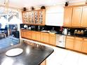Spacious kitchen featuring stainless steel appliances, granite countertops, and custom cabinetry offering ample storage and style at 14711 Potterton Cir, Hudson, FL 34667