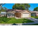 Inviting single-Gathering home with a manicured lawn and a two-car attached garage at 1517 Gunsmith Dr, Lutz, FL 33559