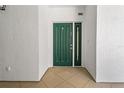 Welcoming entryway with a stylish green front door and neutral tile flooring for a clean and modern appearance at 1586 Gulf Blvd # 2502, Clearwater, FL 33767