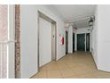 Well-lit hallway featuring tile flooring, elevator access, and convenient access to the unit entrance at 1586 Gulf Blvd # 2502, Clearwater, FL 33767