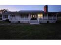 Inviting two-story home with a charming front porch and well-manicured lawn at 17430 Spring Valley Rd, Dade City, FL 33523