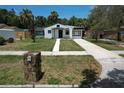 Charming single-story home with a well-maintained front yard and a neatly paved walkway leading to the entrance at 1762 Fulton Ave, Clearwater, FL 33755