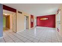 Bright living room showcasing neutral walls, tile floor, and multiple closets at 1799 N Highland Ave # 3, Clearwater, FL 33755