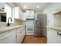 Well-equipped kitchen with white cabinets, stainless steel appliances, and bright natural light at 1828 Foxhunt Dr # A, Sun City Center, FL 33573
