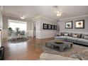 Open-concept living and dining room with neutral tones, wood flooring, and modern furniture at 1828 Foxhunt Dr # A, Sun City Center, FL 33573
