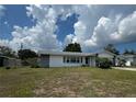 Lovely home with a lush green lawn, charming details, and inviting curb appeal at 2195 Academy Dr, Clearwater, FL 33764