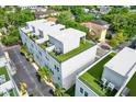 Aerial view of modern townhome rooftops with artificial turf and private rooftop terraces at 2442 W Mississippi Ave # 5, Tampa, FL 33629