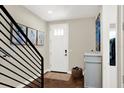 Inviting entryway with hardwood floors, modern staircase, and stylish storage cabinet at 2442 W Mississippi Ave # 5, Tampa, FL 33629