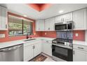 Modern kitchen featuring stainless steel appliances, white cabinetry, and quartz countertops at 2510 Laurelwood Dr # 5B, Clearwater, FL 33763