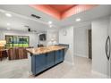 Open-concept living room, blue breakfast bar, and lots of natural light at 2510 Laurelwood Dr # 5B, Clearwater, FL 33763