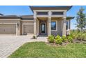 Charming single Gathering home features a two car garage, manicured lawn and stylish portico entrance at 2603 Wise River Ln, Zephyrhills, FL 33541