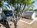 Aerial shot featuring home with a dark roof, lush trees, and an expansive driveway at 3202 Cullendale Dr, Tampa, FL 33618