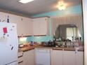 Functional kitchen features white cabinetry and natural light from the window at 33821 Terrace Blvd, Wesley Chapel, FL 33543