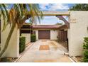 Home featuring an arched entryway, two-car garage, and patterned driveway at 3476 Tarpon Woods Blvd, Palm Harbor, FL 34685