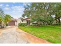 Charming single-story home featuring a tile roof and an attached garage at 3476 Tarpon Woods Blvd, Palm Harbor, FL 34685