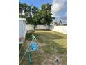Spacious backyard with a white fence, offering privacy and space for outdoor activities and relaxation at 3612 Devonshire Dr, Holiday, FL 34691