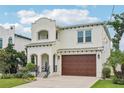 Charming two-story stucco home with covered front porch, two-car garage, and lush landscaping at 4115 N Blvd, Tampa, FL 33603