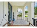 Inviting front porch featuring decorative tiling, an accent tree, and a relaxing porch swing at 4115 N Blvd, Tampa, FL 33603