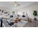 Bright living room with vaulted ceiling, modern ceiling fan, comfortable seating, and natural light at 4121 W San Nicholas St, Tampa, FL 33629