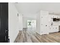 Bright, freshly renovated living area with new floors flowing to a modern, updated kitchen at 4461 Shore Acres Ne Blvd, St Petersburg, FL 33703
