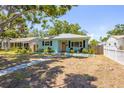 Exterior view of a well-maintained single-story home with a manicured lawn, and a charming fence at 4531 7Th N Ave, St Petersburg, FL 33713