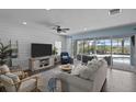 Comfortable living room featuring a large sliding glass door with views of the pool and modern decor at 4770 Ballantrae Blvd, Land O Lakes, FL 34638