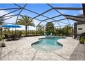 Relax in this inviting screened-in pool, complete with an adjacent patio area for outdoor dining at 4770 Ballantrae Blvd, Land O Lakes, FL 34638