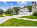Two-story home with an attached two-car garage, basketball hoop, and well-maintained lawn at 5005 W Evelyn Dr, Tampa, FL 33609