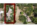 Aerial view showcases the home's large lot surrounded by lush greenery at 5680 77Th N Ave, Pinellas Park, FL 33781