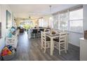 Bright dining area featuring a table set for four with views of the living space and outdoor at 5701 Bahia Del Mar Cir # 108, St Petersburg, FL 33715