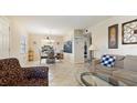 Open-concept living area showcasing tile floors, dining area, and comfortable seating, offering a bright and welcoming atmosphere at 6100 Gulfport S Blvd # 415, Gulfport, FL 33707