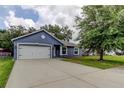 Charming one-story home featuring a spacious driveway, garage, and manicured lawn at 6145 103Rd N Ave, Pinellas Park, FL 33782