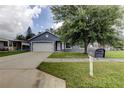 Charming one-story home featuring a well-manicured front yard with lush green grass at 6145 103Rd N Ave, Pinellas Park, FL 33782