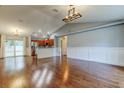 Open living room boasts hardwood floors and flows into kitchen and dining area at 6145 103Rd N Ave, Pinellas Park, FL 33782